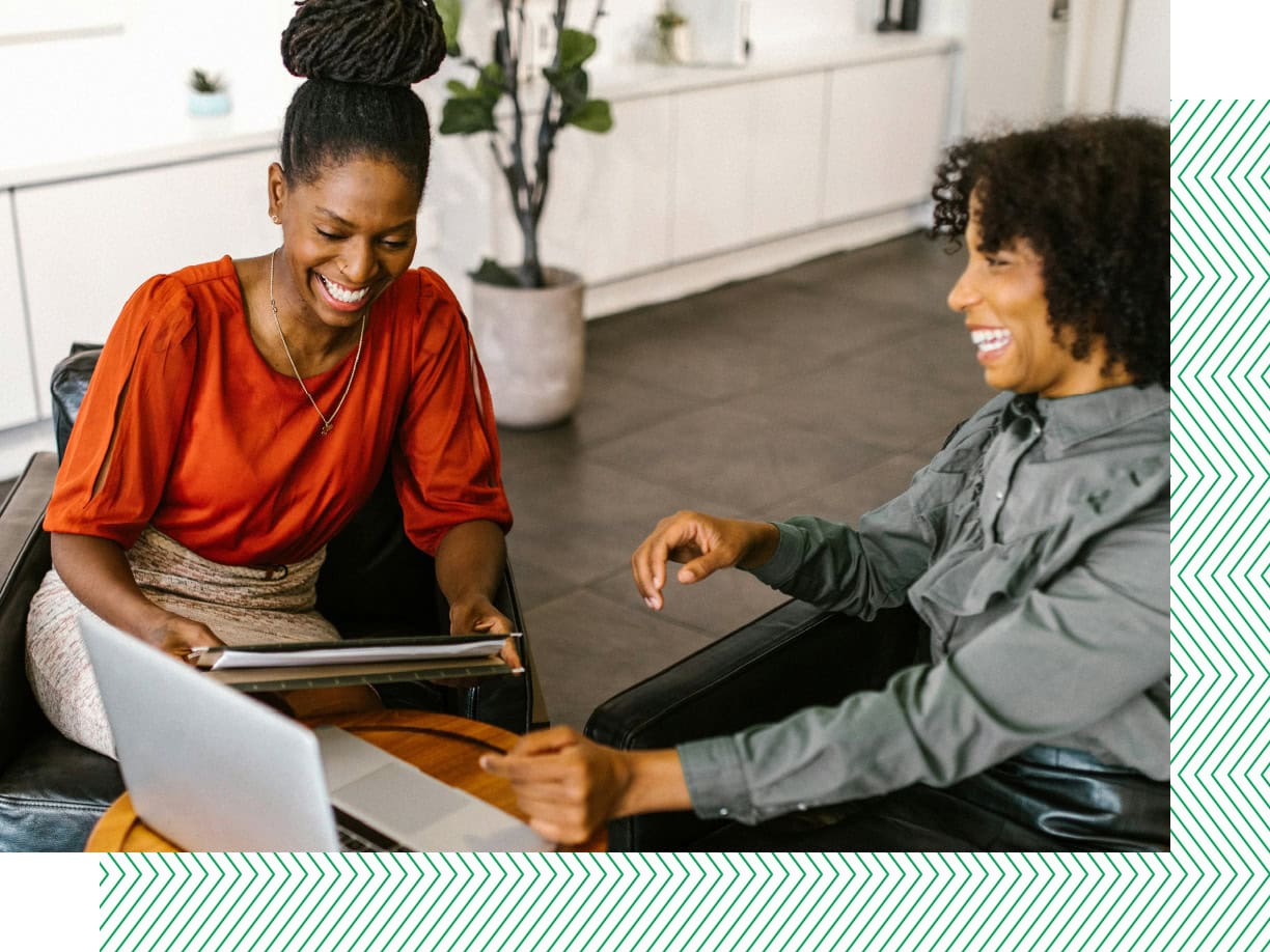 two women smiling in the office